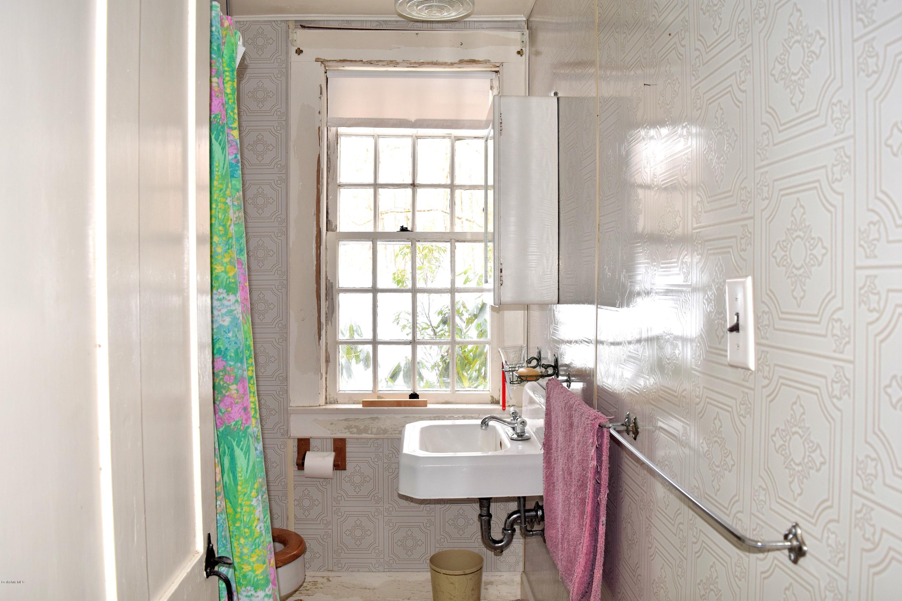 246 Judd Road Otis, MA 01253 - Photo 14 of 21 a bathroom with a sink a toilet and a window