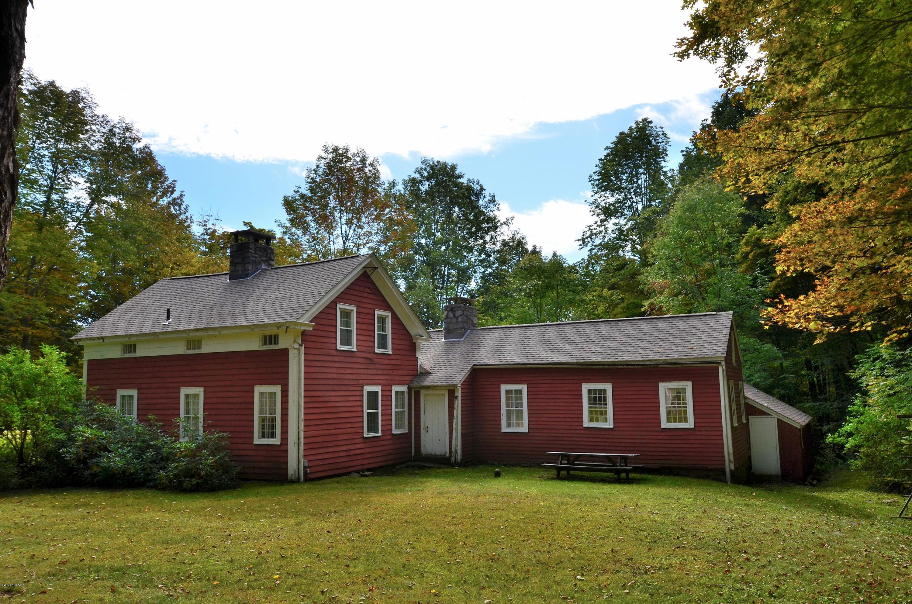246 Judd Road Otis, MA 01253 - Photo 3 of 21 a house that is sitting in the grass with large trees