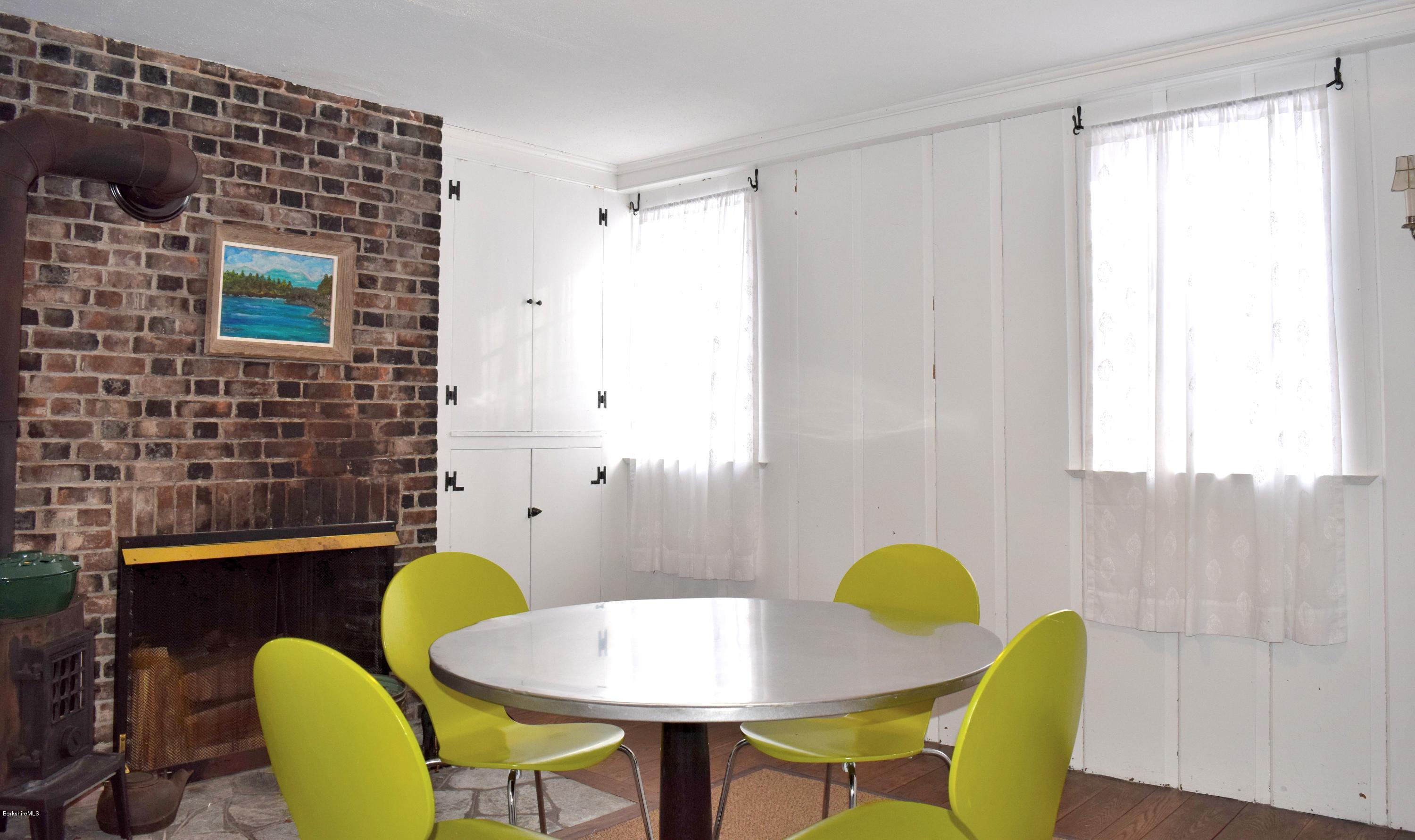 246 Judd Road Otis, MA 01253 - Photo 7 of 21 a view of a dining room with furniture and wooden floor