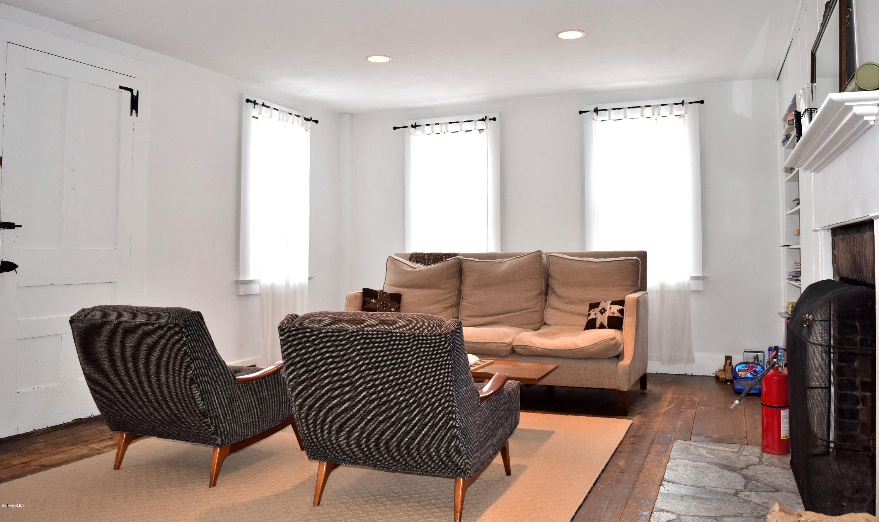 246 Judd Road Otis, MA 01253 - Photo 8 of 21 a living room with furniture and a fireplace