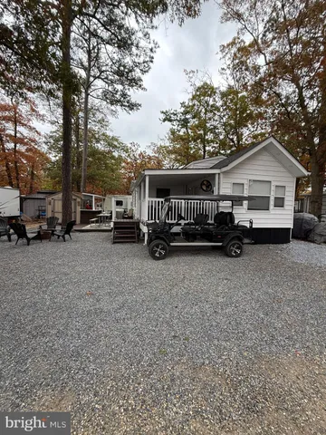 a view of a house with a patio and a yard