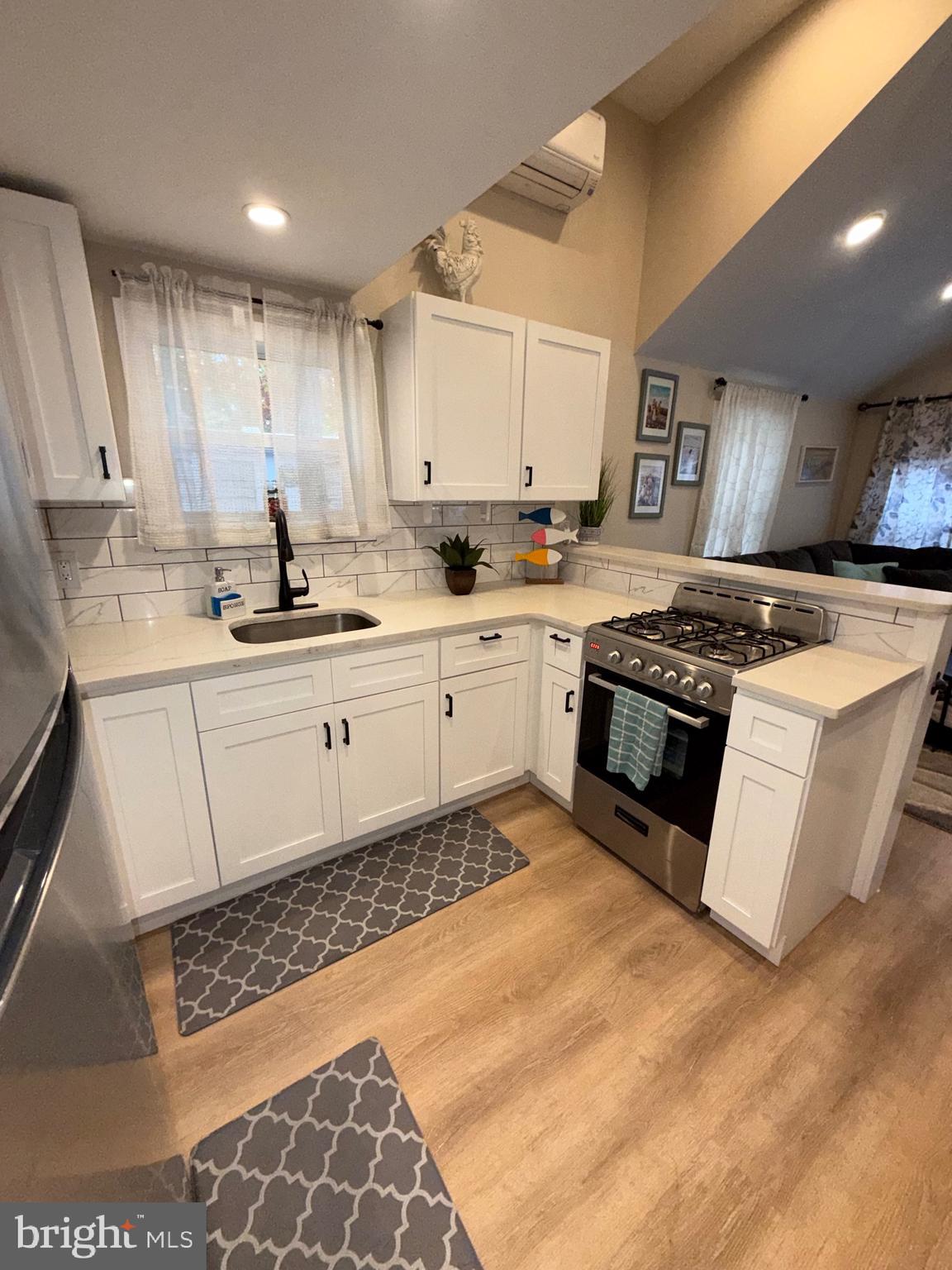 515 Corsons Tavern Road, Unit D22 Ocean View, NJ 08230 - Photo 4 of 23 a kitchen with stainless steel appliances granite countertop a stove a sink and a microwave