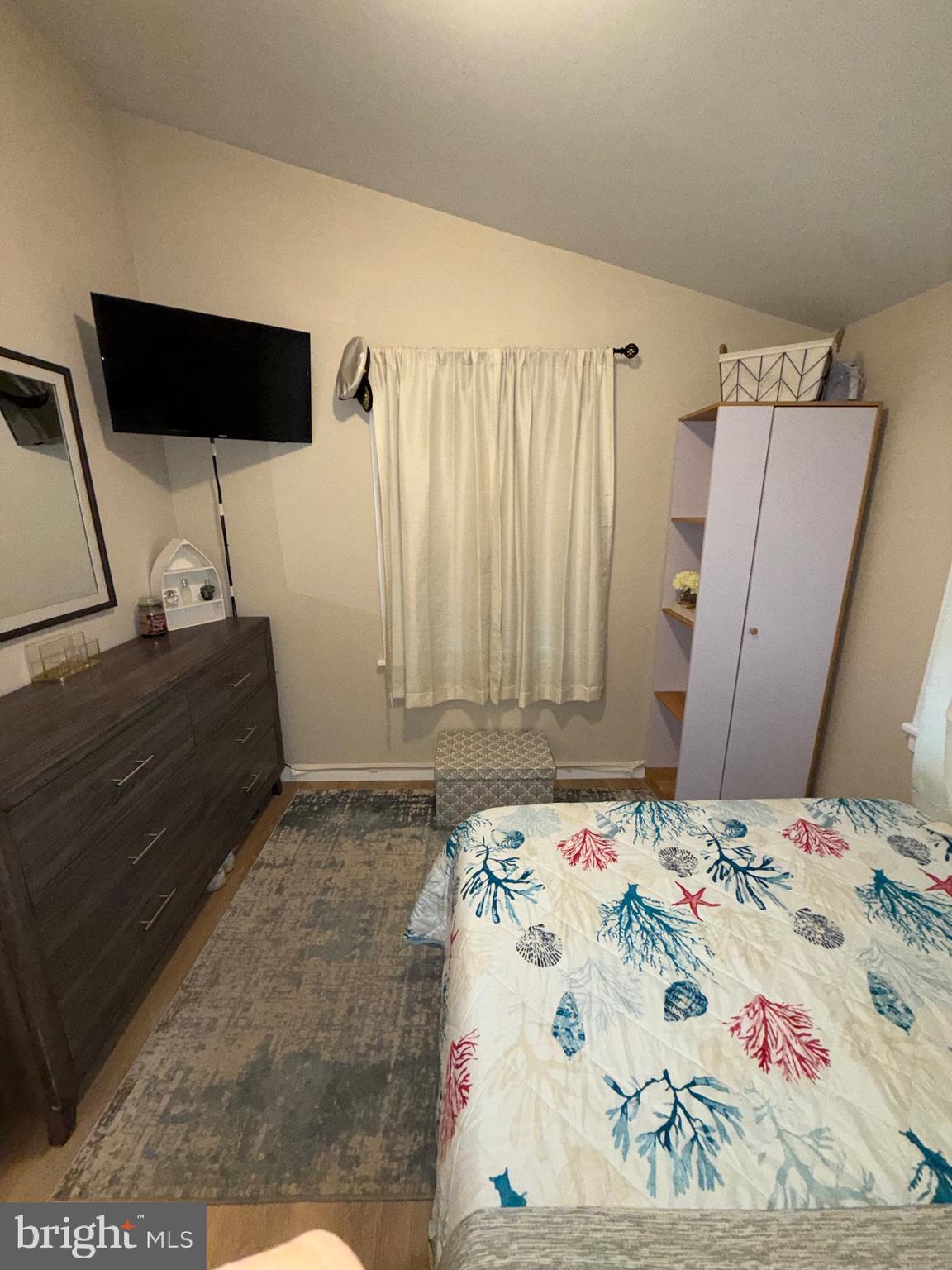 515 Corsons Tavern Road, Unit D22 Ocean View, NJ 08230 - Photo 8 of 23 a bedroom with a bed and a flat screen tv