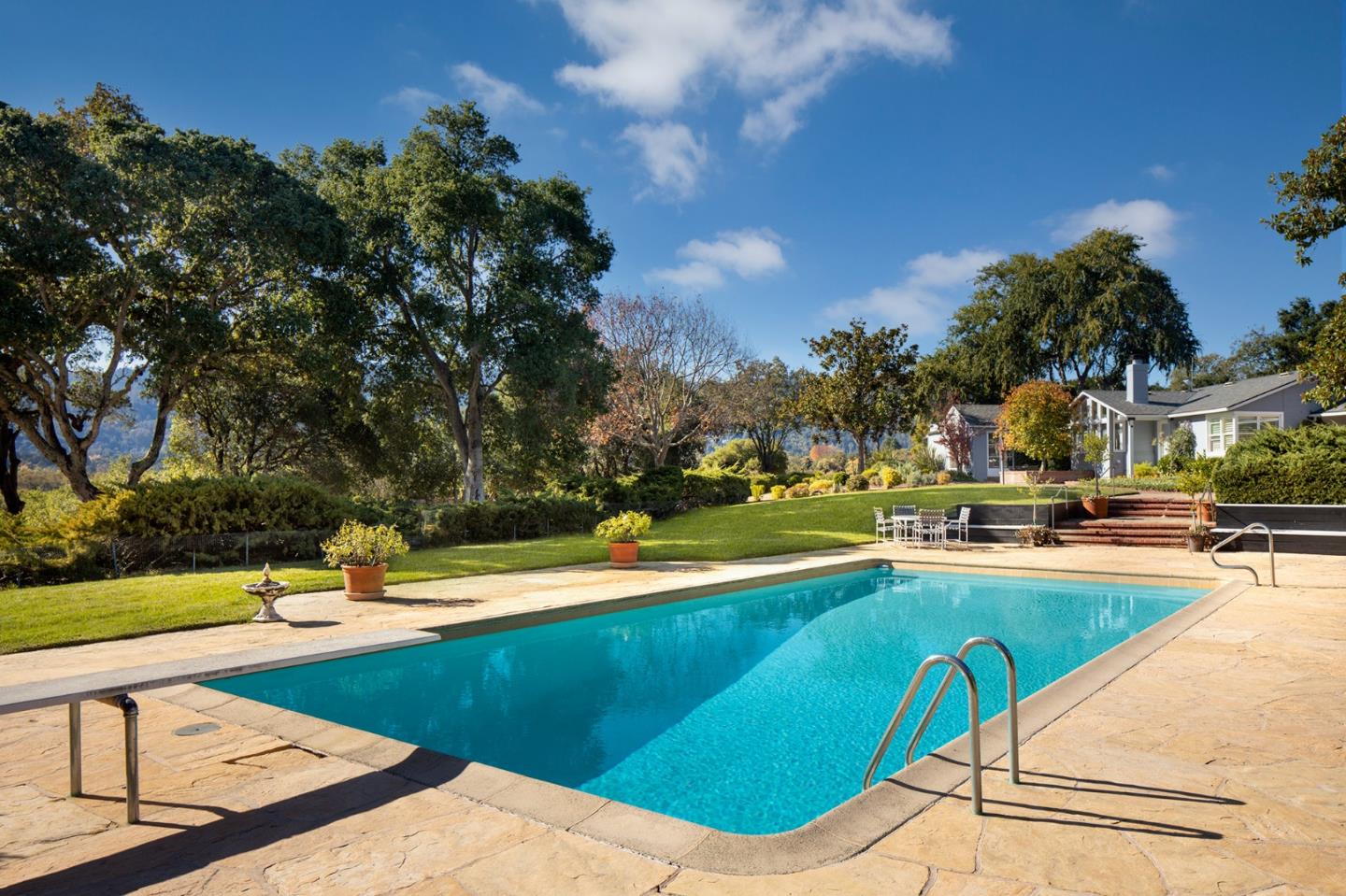 a view of a swimming pool with a lawn chairs