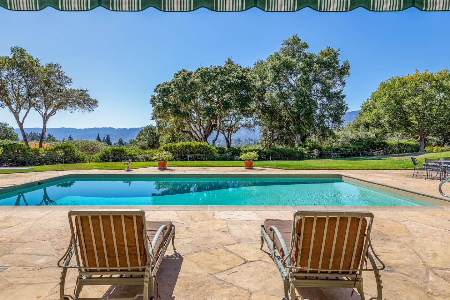 2885 Woodside Road Woodside, CA 94062 - Photo 3 of 19 a view of a swimming pool with an outdoor seating and a yard