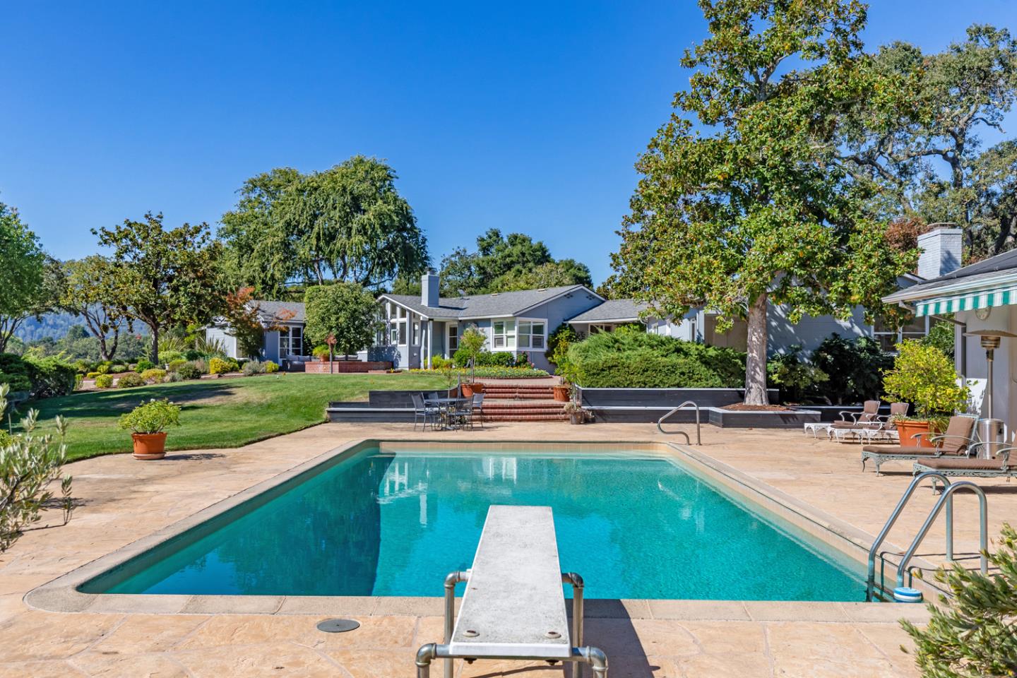 2885 Woodside Road Woodside, CA 94062 - Photo 4 of 19 a view of a house with swimming pool and sitting area