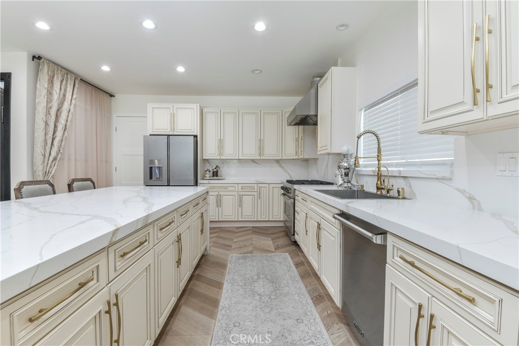 9728 Rhea Avenue Northridge, CA 91324 - Photo 11 of 36 a large kitchen with stainless steel appliances granite countertop a sink and cabinets