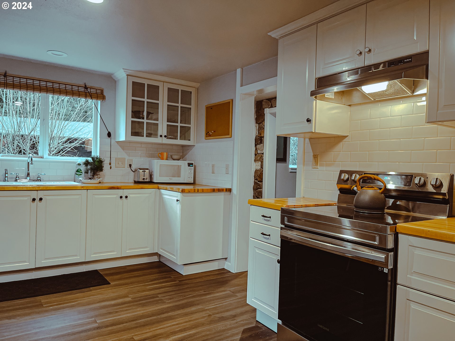9010 Southeast Bull Run Road Corbett, OR 97019 - Photo 7 of 21 a kitchen with a stove and a microwave