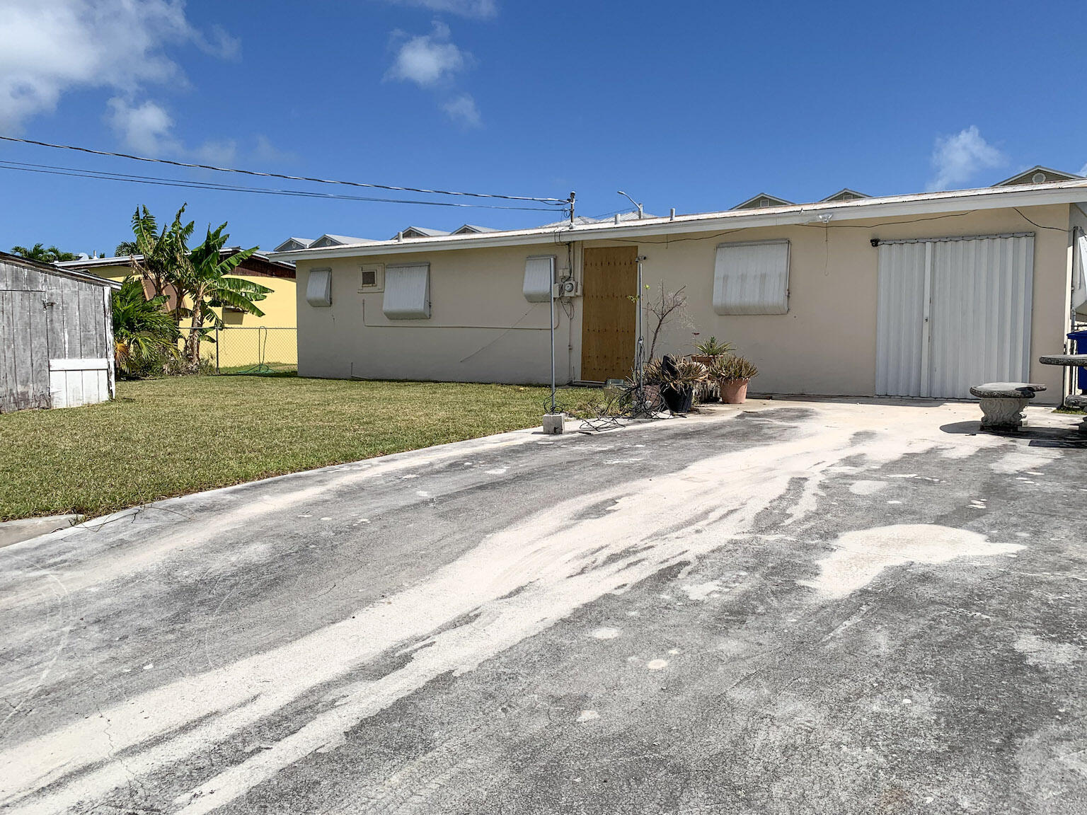 17 6th Avenue Stock Island, FL 33040 - Photo 3 of 28 a front view of a house with a yard and garage