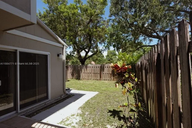 a view of a backyard with pathway