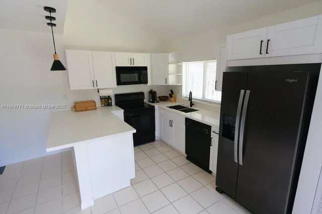 a kitchen with stainless steel appliances a refrigerator sink and microwave