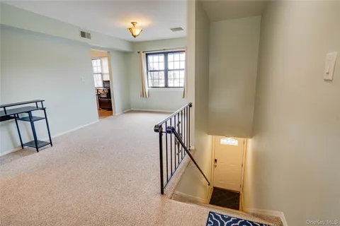 a view of a hallway with windows