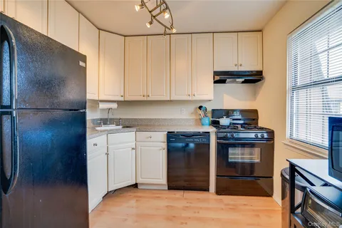 a kitchen with stainless steel appliances granite countertop a refrigerator stove and sink