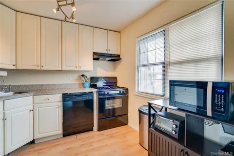 a kitchen with stainless steel appliances granite countertop a stove sink and cabinets