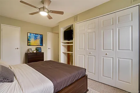 a bedroom with a large bed and a chandelier