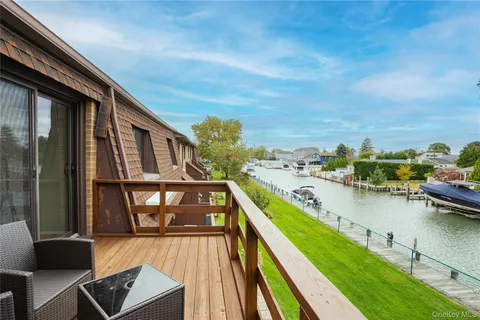 a view of a balcony with chairs and wooden floor