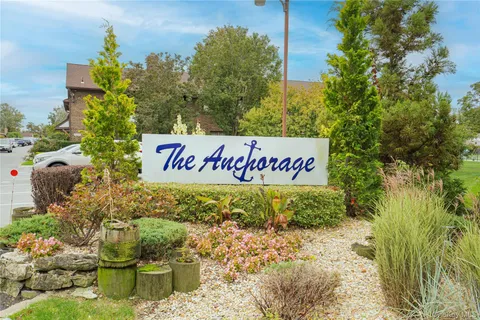 a sign that is sitting in front of flowers