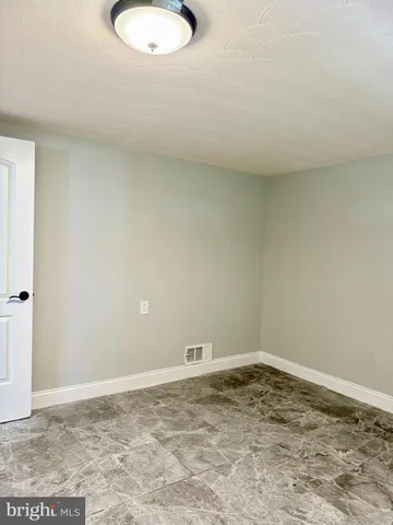 a view of a room with hardwood floor and a ceiling fan
