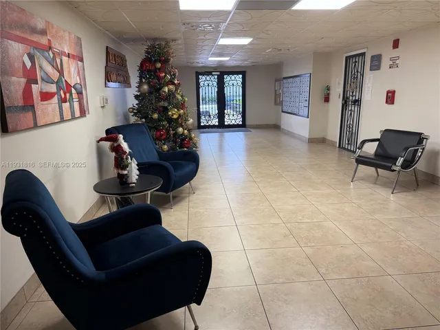 a living room with furniture and flowers