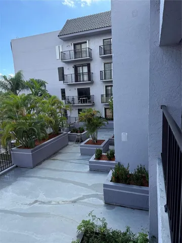 front view of a house with potted plants