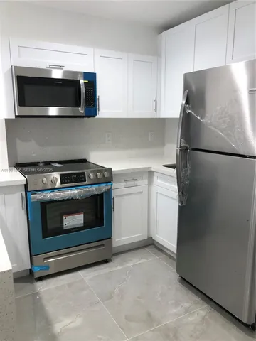 a kitchen with a stove and a microwave