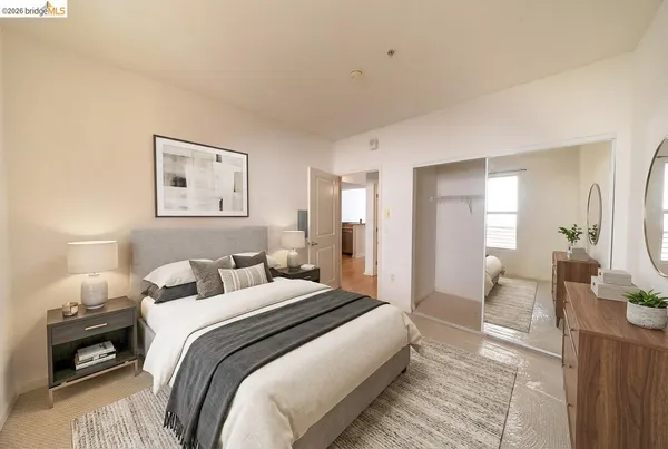 a spacious bedroom with a bed and a large window