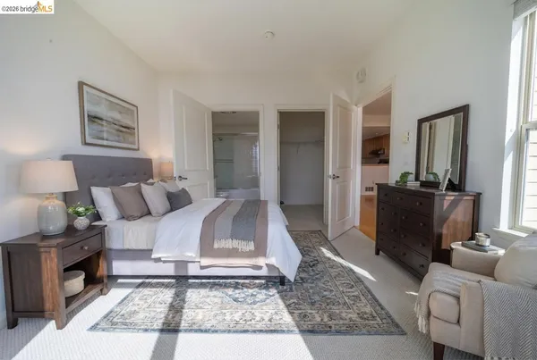 a spacious bedroom with a bed and a window