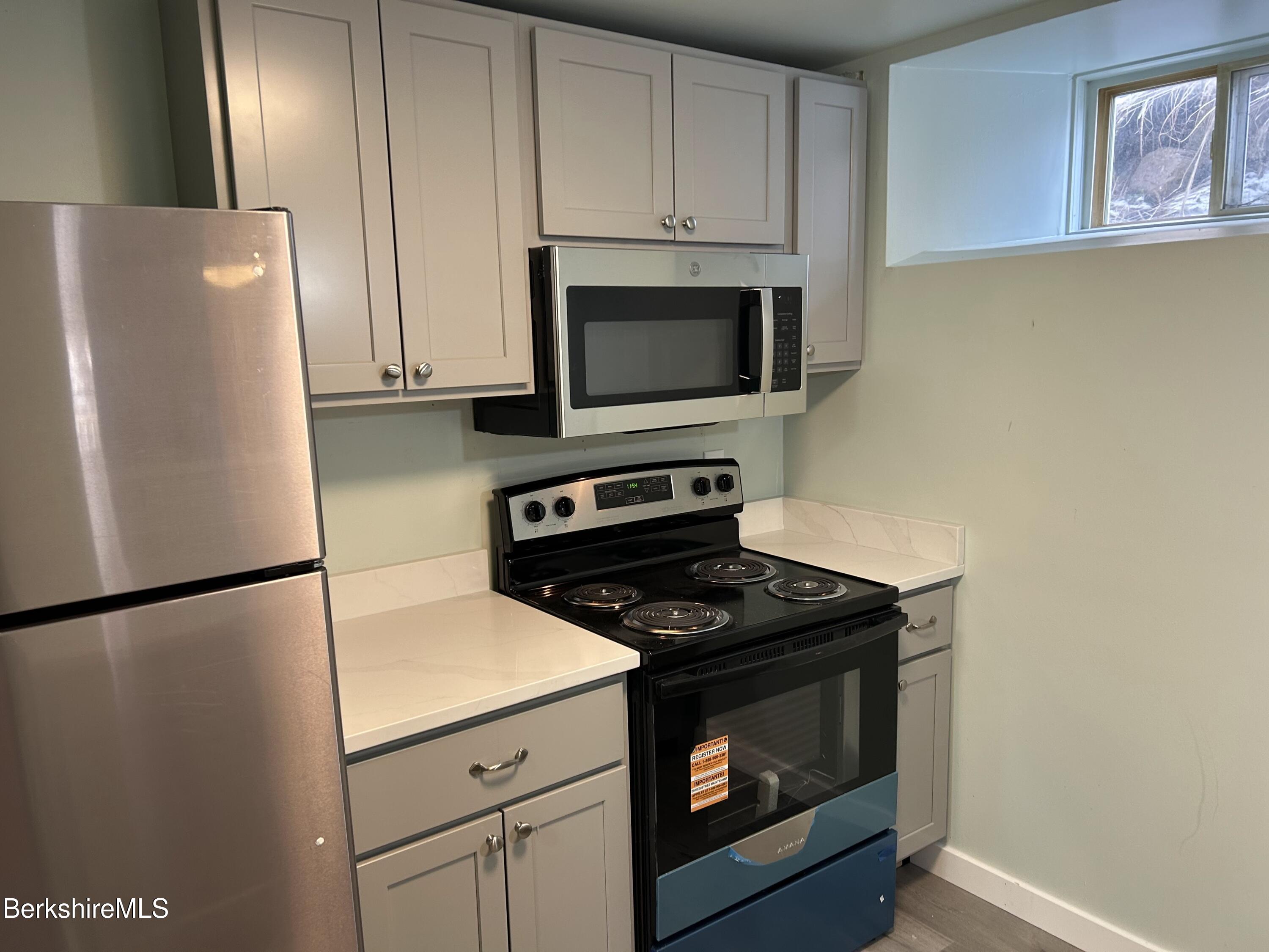 1 Pebble Street, Unit B North Adams, MA 01247 - Photo 3 of 14 a kitchen with cabinets and a stove top oven