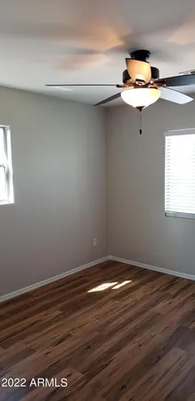 a view of a small space with wooden floor and a window