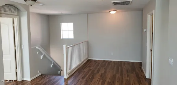 a view of hallway with wooden floor