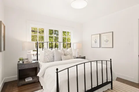 a bedroom with furniture and a window