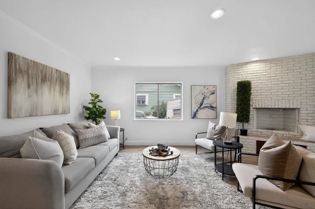 a living room with furniture and a potted plant