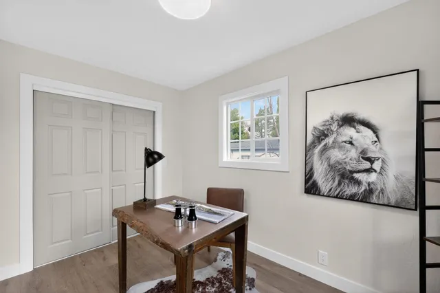 a view of a workspace with furniture and a window