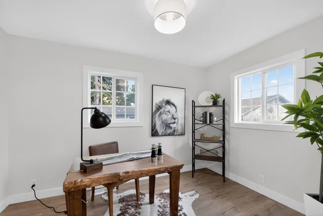a view of a workspace with a table and chair