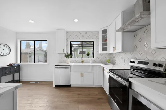 a kitchen with a sink stove and cabinets