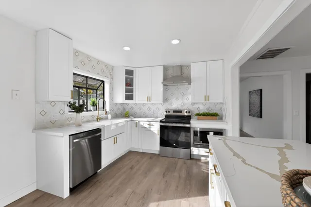 a kitchen with a sink stove and refrigerator
