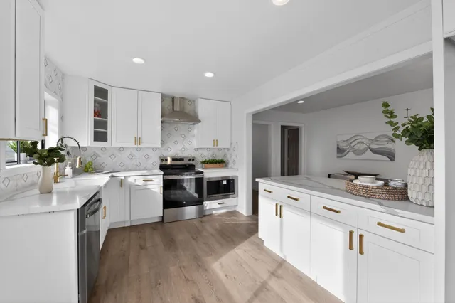 a kitchen with a sink stove and cabinets