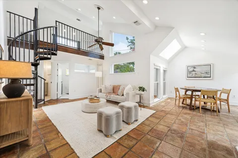 a living room with lots of furniture and a wooden floor