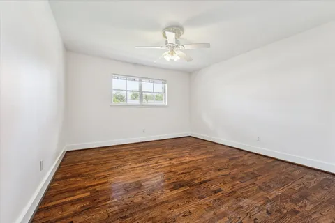 a bathroom with a granite countertop sink a mirror and a bathtub