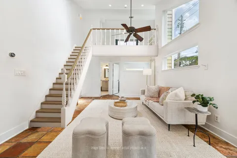 a front view of a house with yard and green space