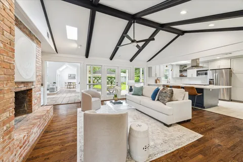 a living room with furniture wooden floor and a fireplace