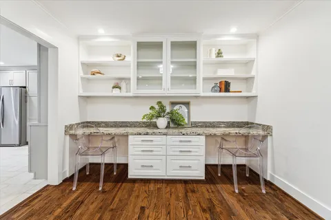 a large kitchen with a table and chairs