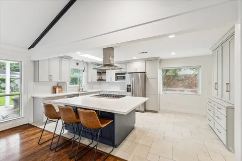 a kitchen with stainless steel appliances granite countertop a stove and a sink