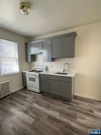 a kitchen with a sink cabinets and window