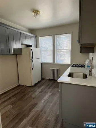 a kitchen that has a sink and a stove in it