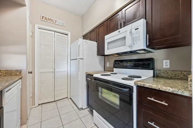 a kitchen with cabinets and steel stainless steel appliances