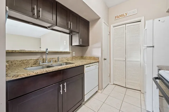 a kitchen with stainless steel appliances granite countertop a sink and a cabinets