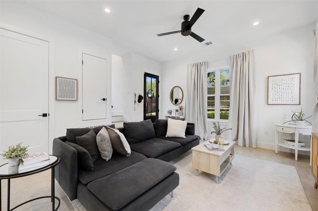 5007 Lott Avenue, Unit 1 Austin, TX 78721 - Photo 3 of 24 A comfortable living space featuring a deep charcoal sectional and abundant natural light.