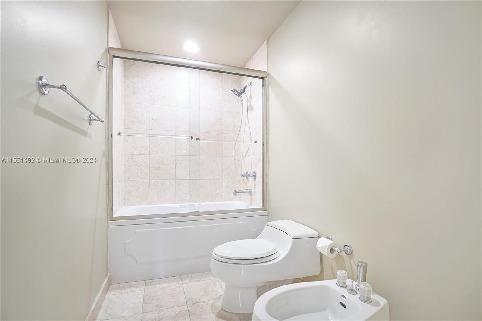 848 Brickell Key Drive, Unit 2003 Miami, FL 33131 - Photo 16 of 35 a bathroom with a toilet and shower