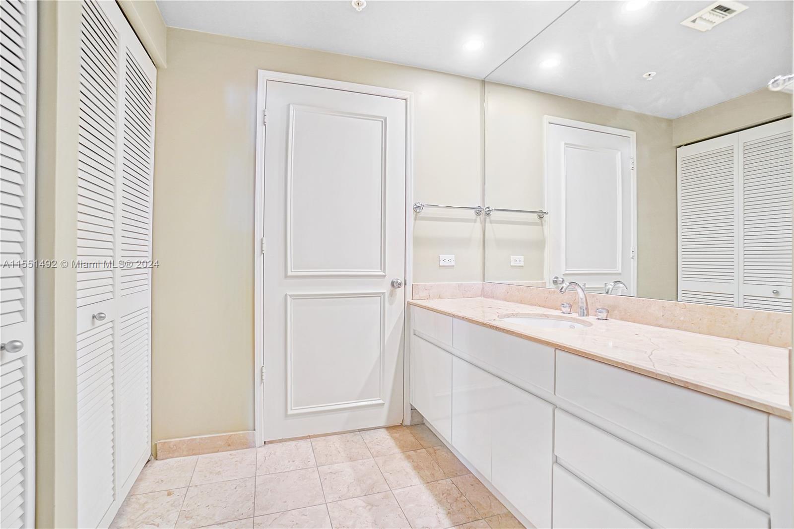 848 Brickell Key Drive, Unit 2003 Miami, FL 33131 - Photo 19 of 35 a bathroom with a sink and a mirror
